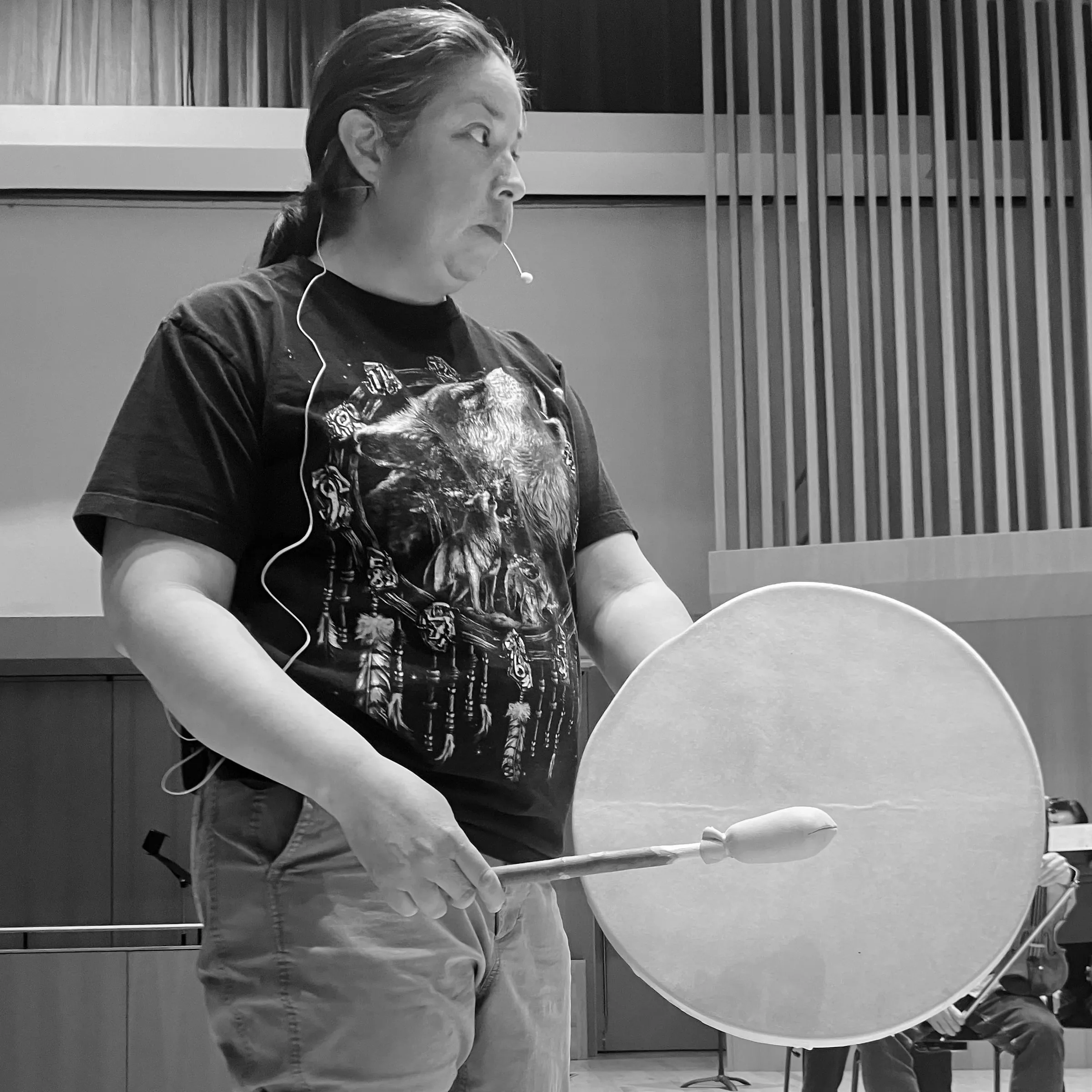 Mi’kmaw performance and installation artist, Ursula Johnson in rehearsal, playing a drum.